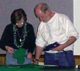 Nancy and Dick hot glueing the shamrocks to the fabric
